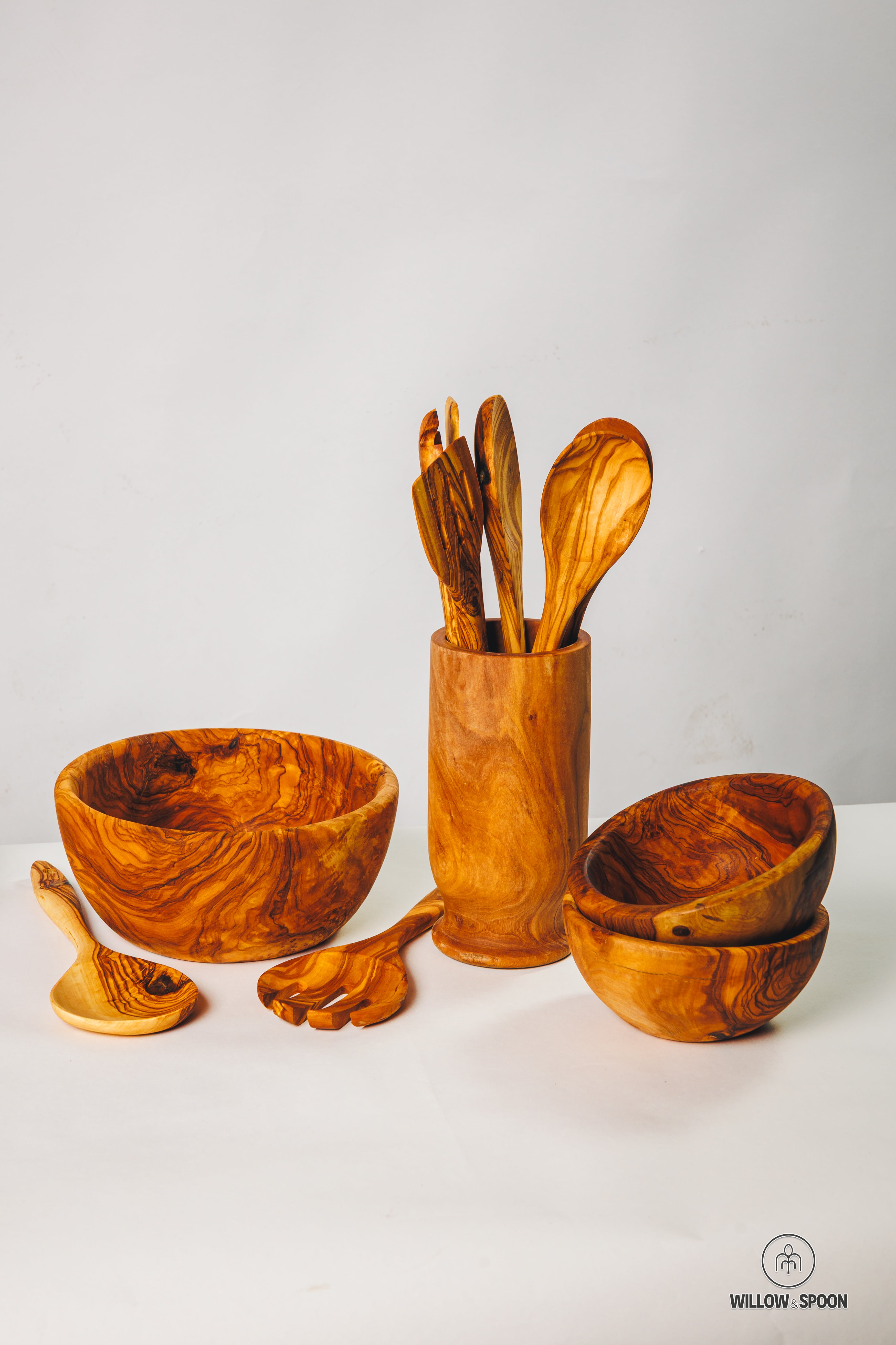 A comprehensive showcase of Willow & Spoon's handcrafted olive wood collection, featuring dinnerware, serving bowls, and artisan utensils.