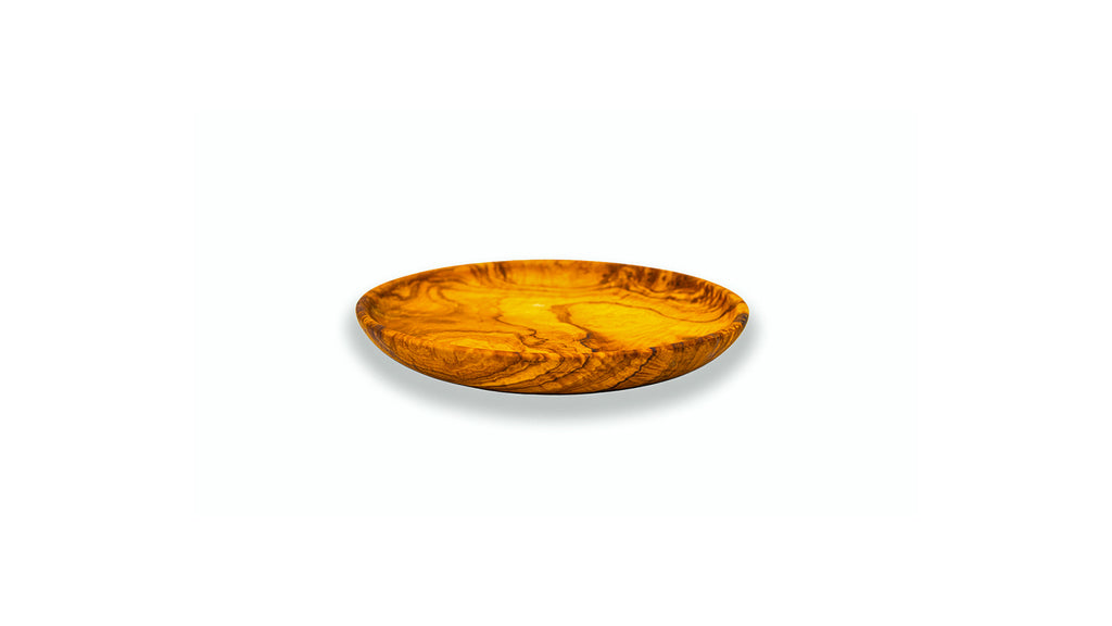 Side profile of a thin, artisan olive wood appetizer plate, highlighting the sleek handcrafted edges.