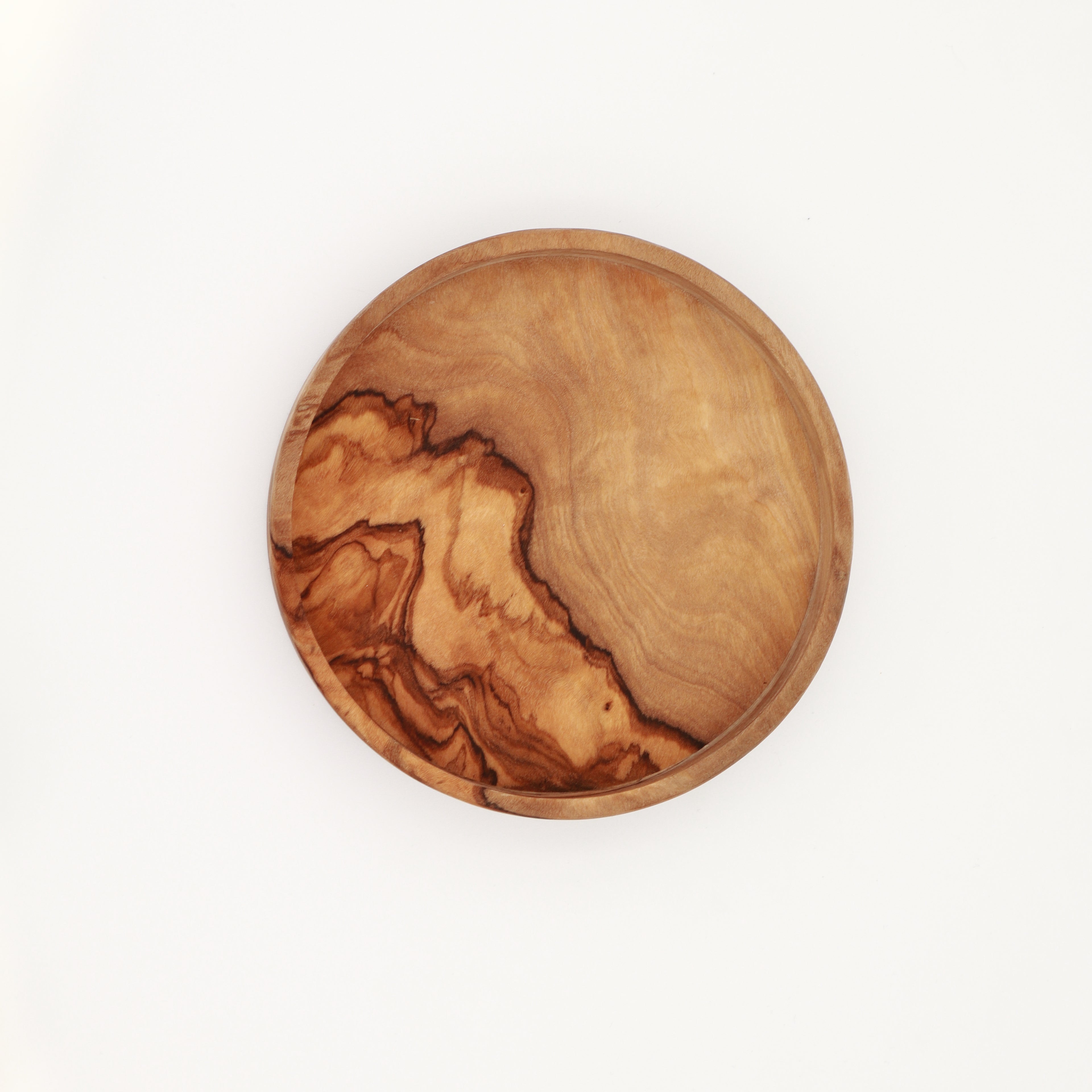  Overhead view of a handcrafted Tunisian olive wood dipping dish showing the natural grain on a white background.