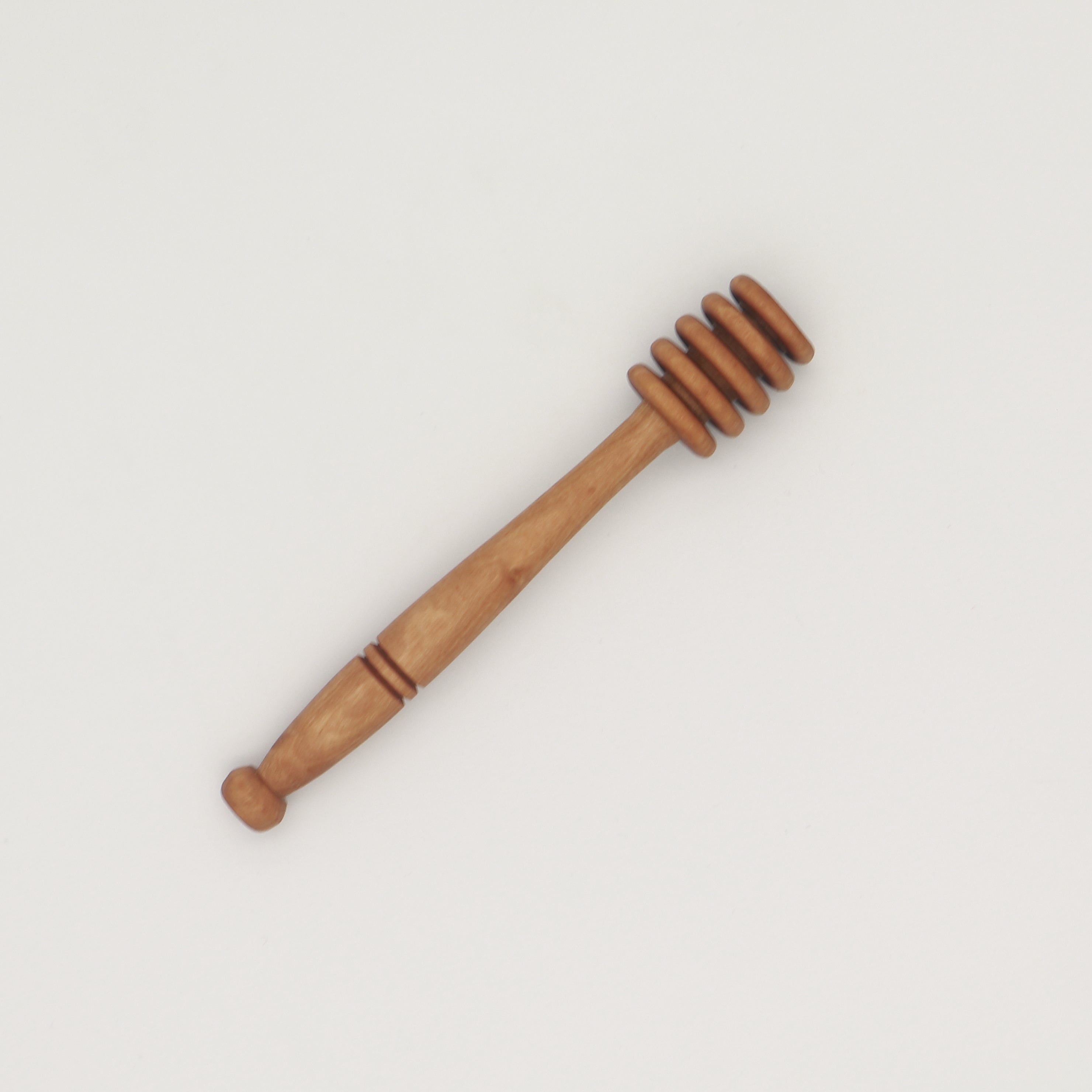 Handcrafted olive wood honey dipper with turned grooves and tapered handle.