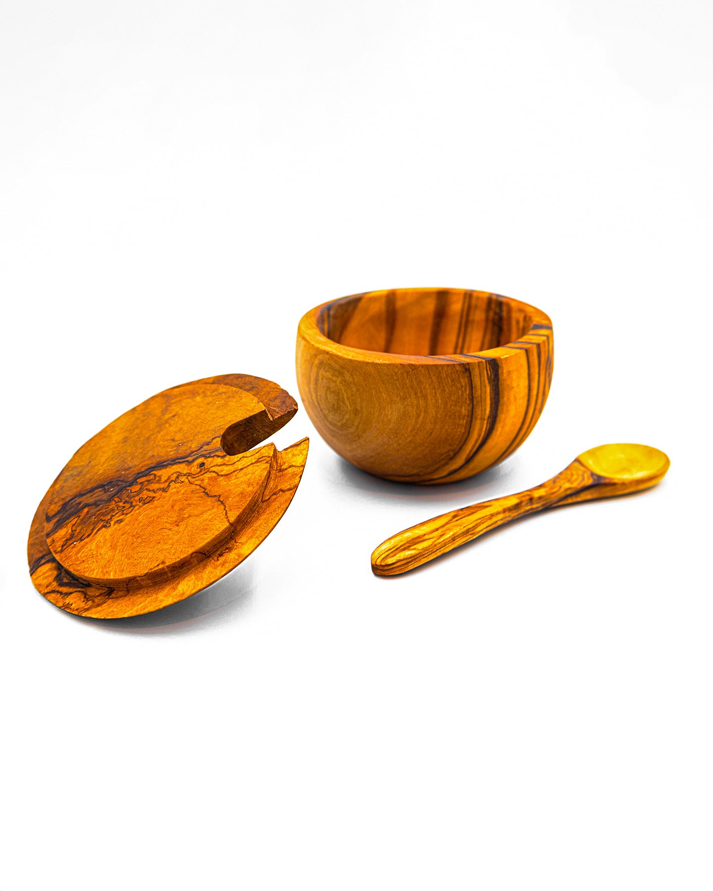 Single olive wood pinch pot open with the lid set aside to show the spice compartment and artisan spoon.