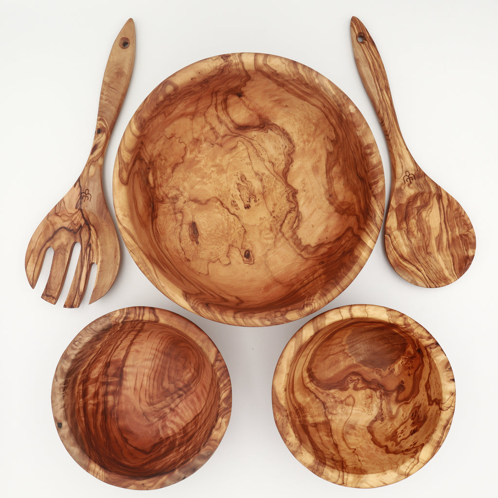 Handcrafted Tunisian olive wood salad set with large serving bowl, two salad servers, and two side bowls on white background.