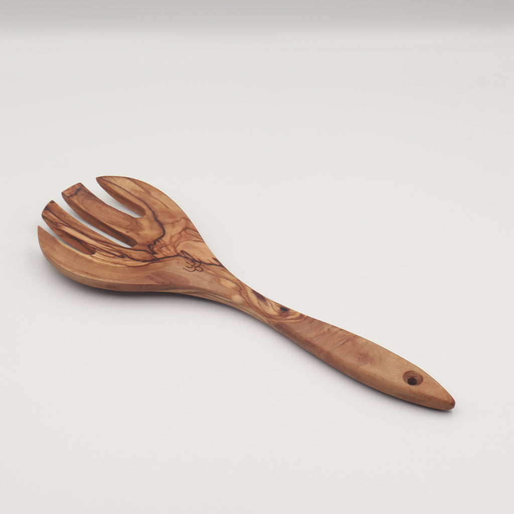Handcrafted Tunisian olive wood salad server fork shown on a white background highlighting the natural grain.