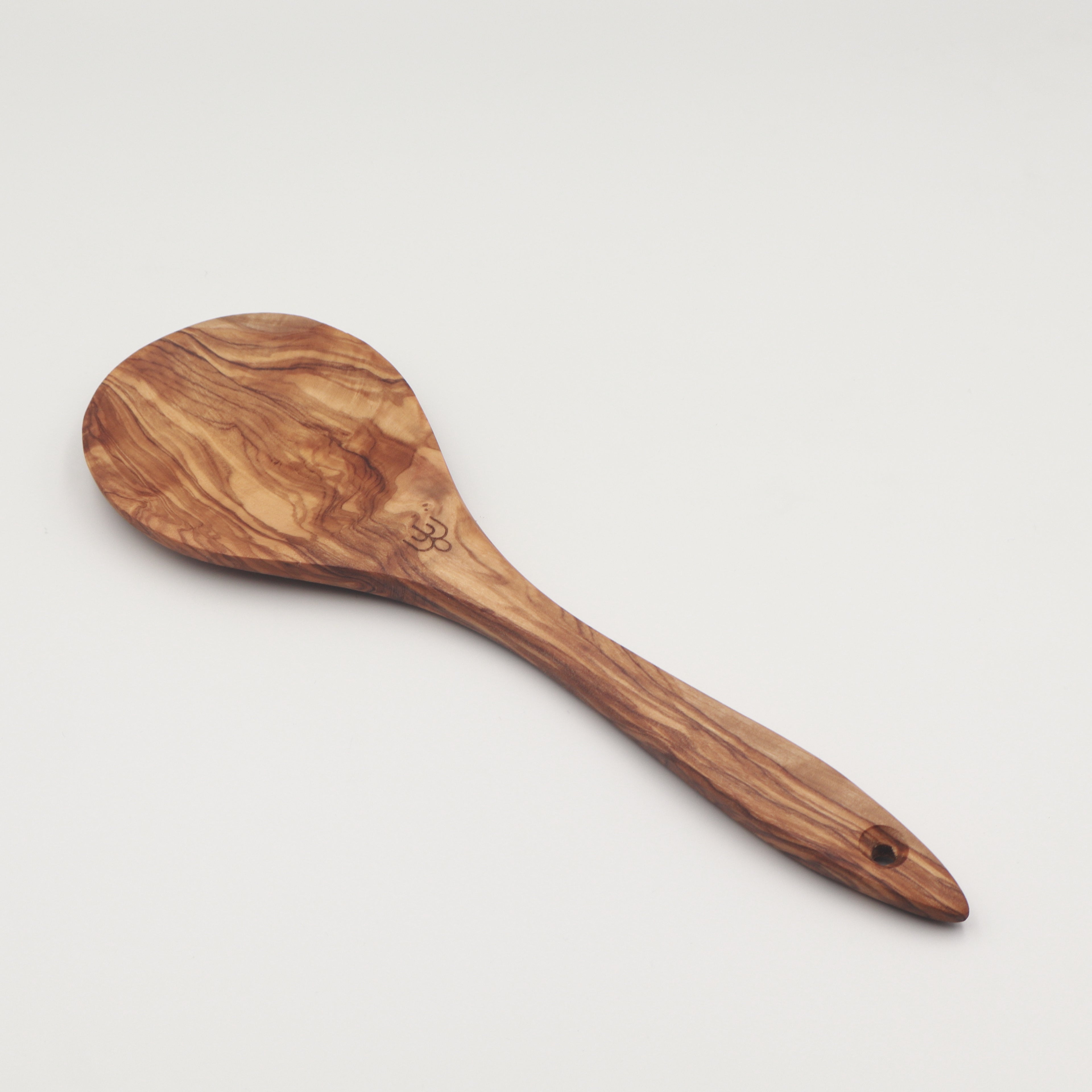Handcrafted Tunisian olive wood salad server spoon shown on a white background, featuring the Willow & Spoon engraved mark.
