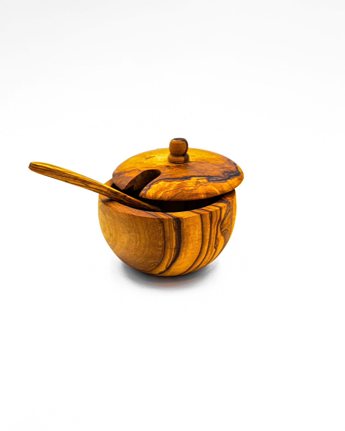 Handcrafted single olive wood salt cellar with a closed swivel lid and matching mini spoon.