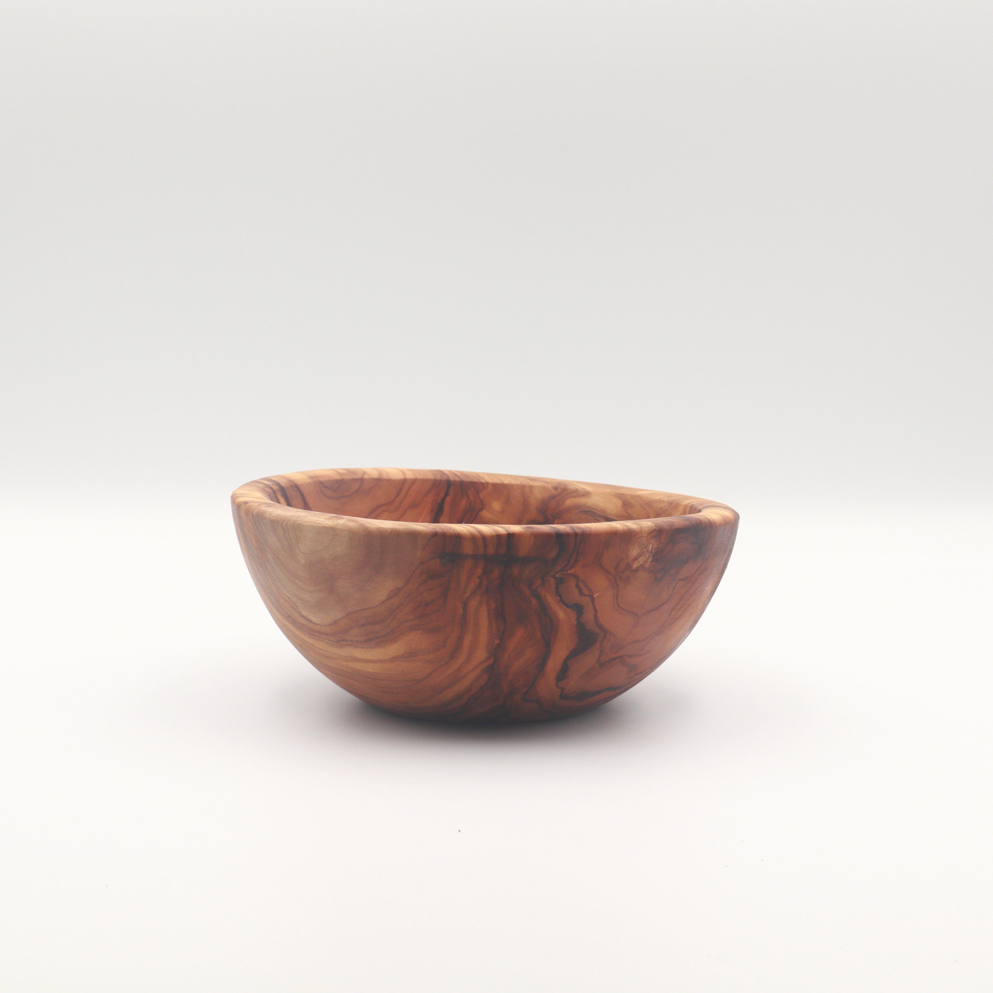 Single handcrafted Tunisian olive wood small bowl shown on a white background highlighting the natural grain.