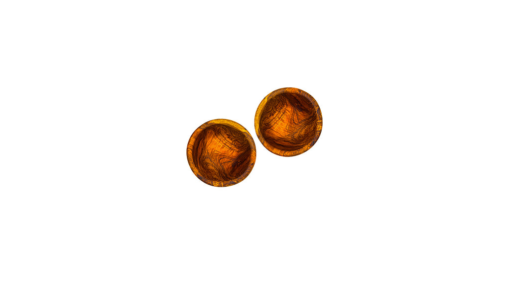 A pair of small handcrafted olive wood bowls with a deep, natural grain, perfect for kitchen prep or serving individual portions of nuts and olives.