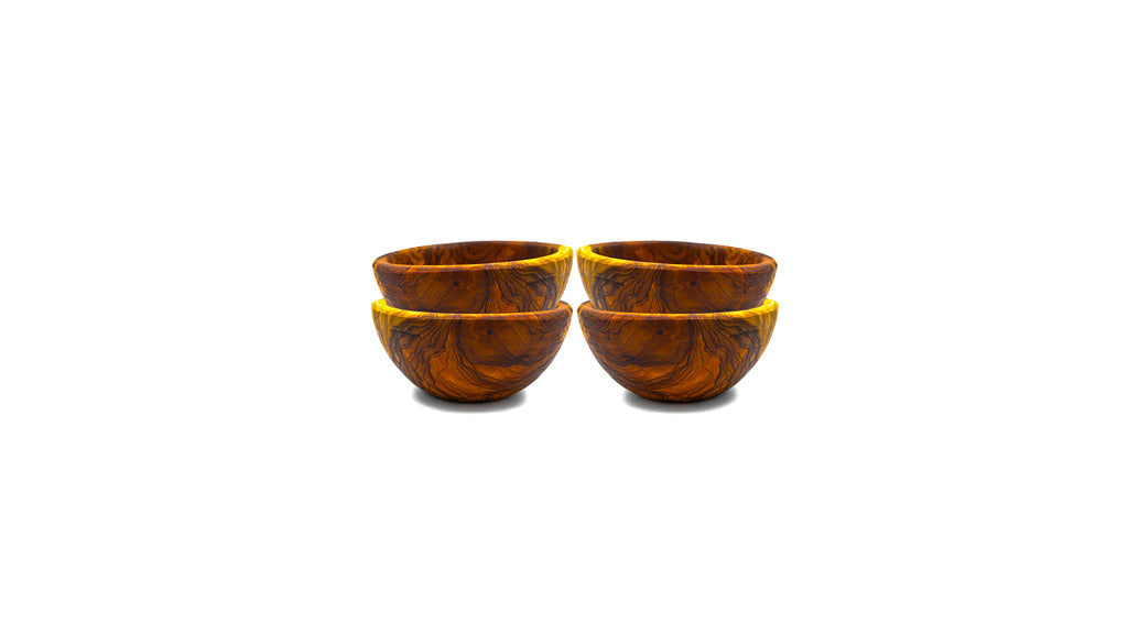 Set of four small handcrafted olive wood snack bowls with rich marbled grain, stacked on a white background.