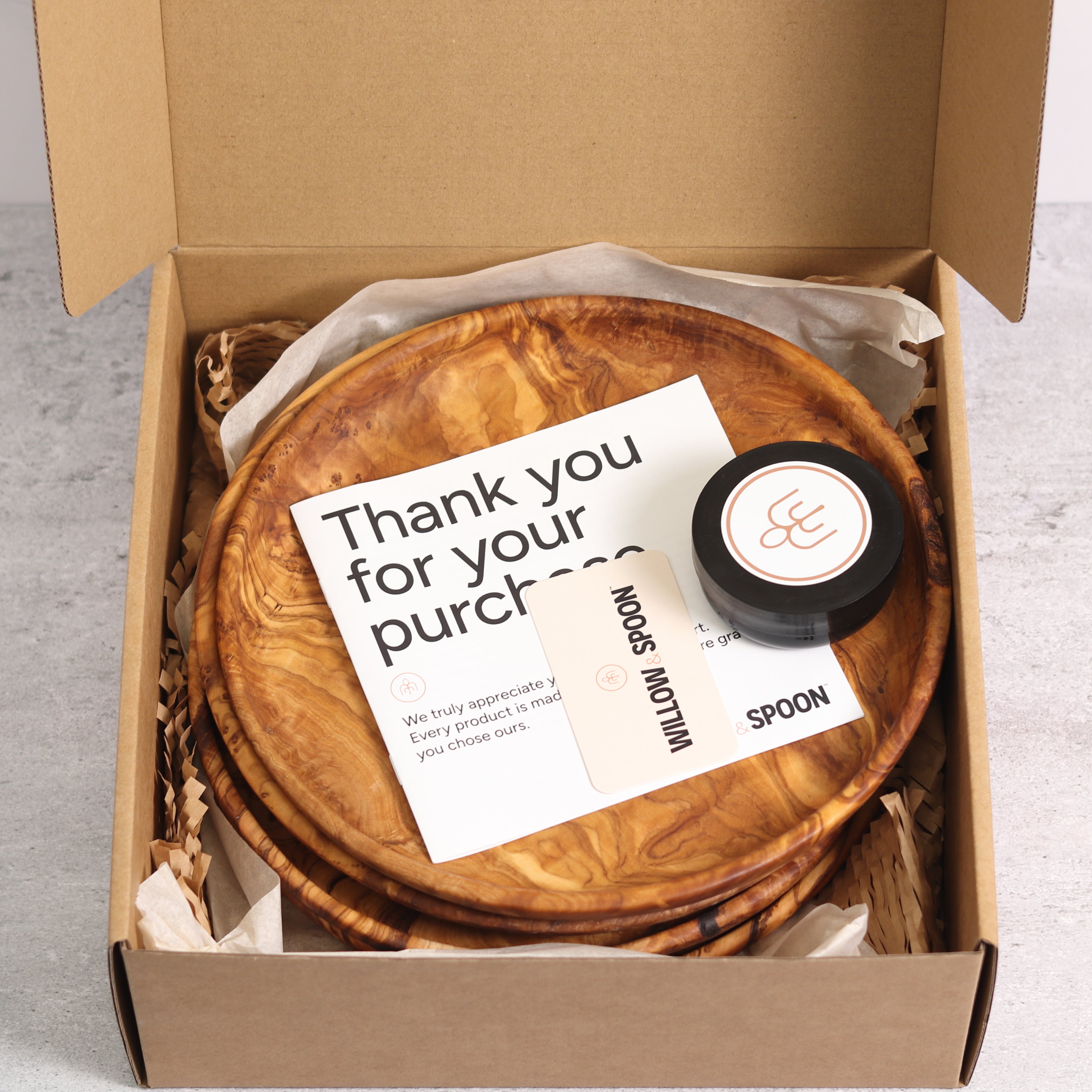 Olive wood dinner plates packaged in a Willow & Spoon gift box with tissue paper, branded coaster, and thank you card
