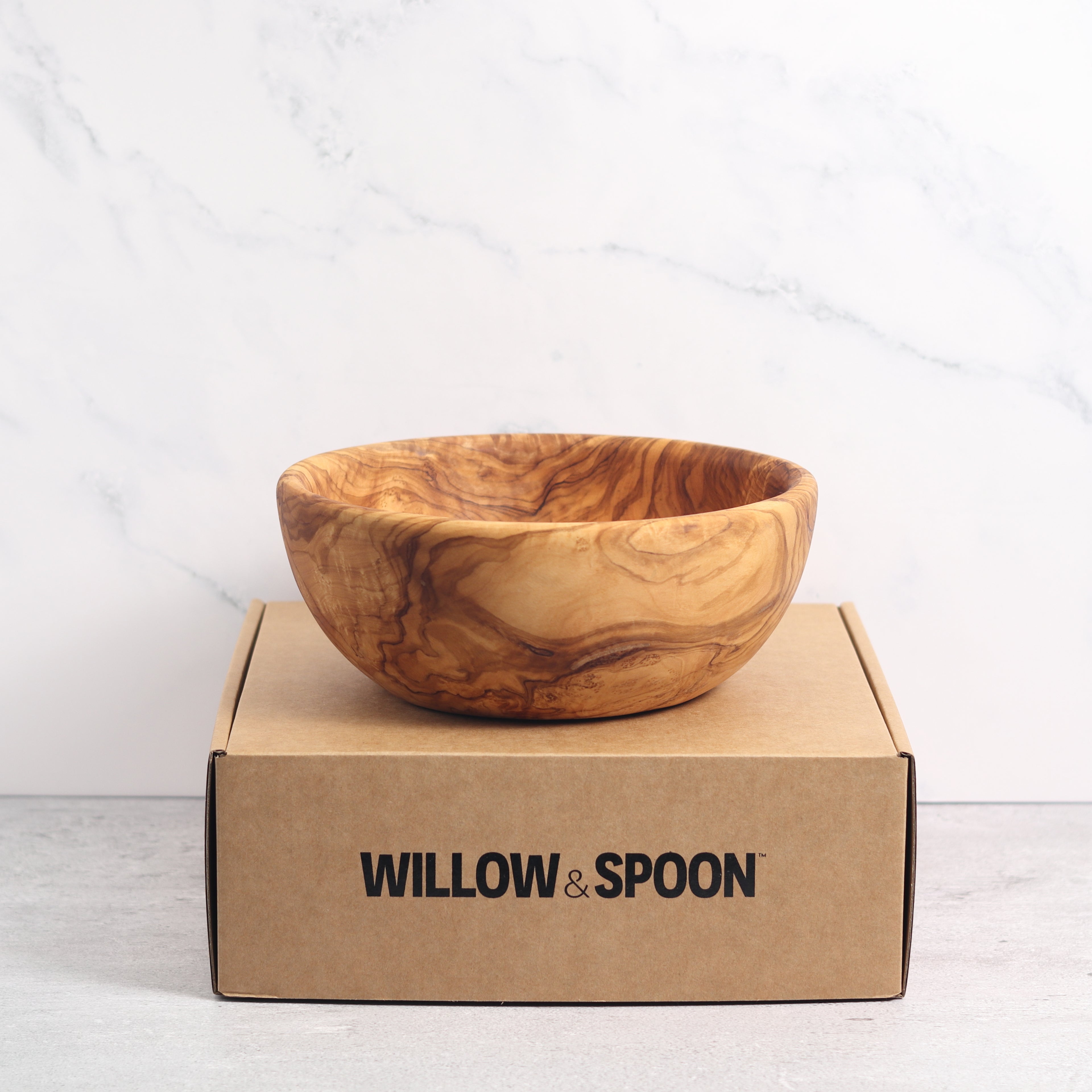 Olive wood salad bowl displayed on a Willow & Spoon branded box against a marble background